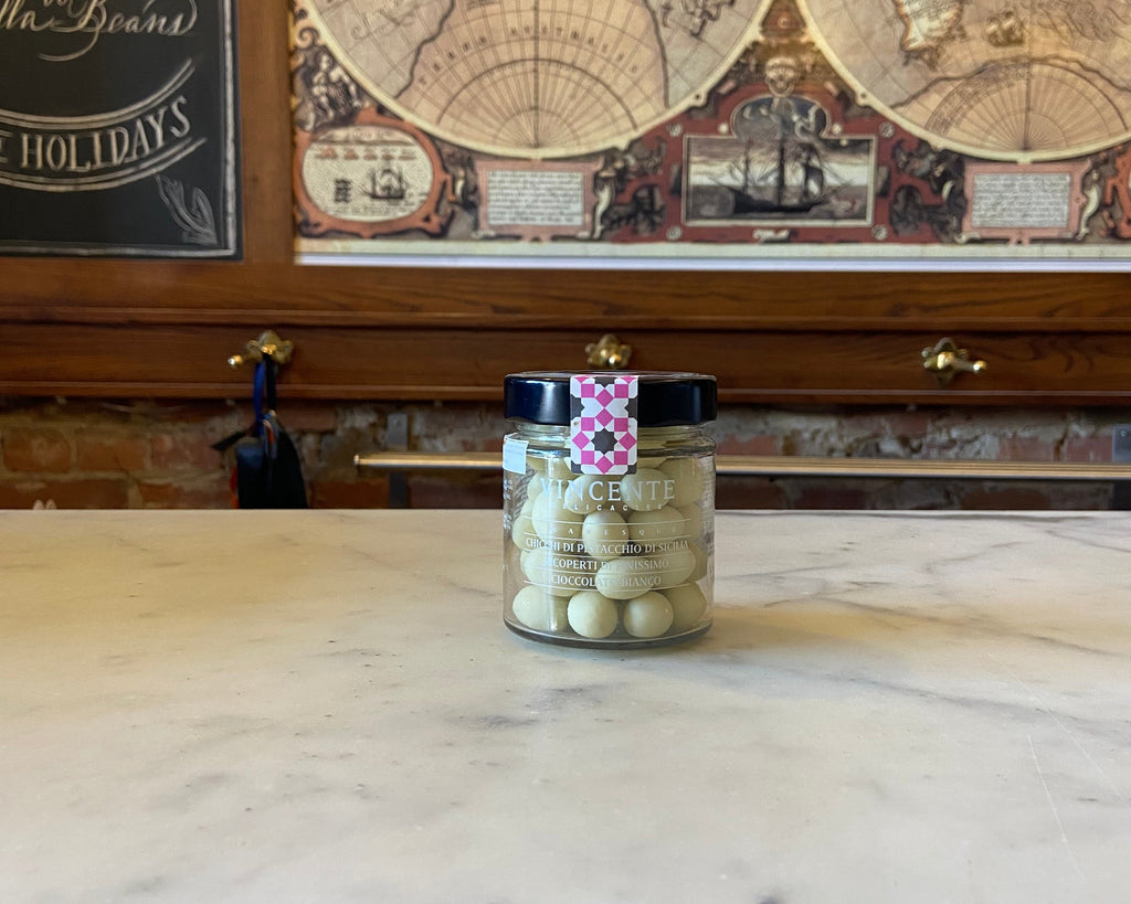 chocolate covered pistachios in a glass jar