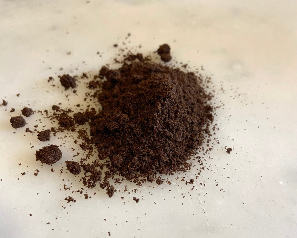 ground vanilla bean on marble